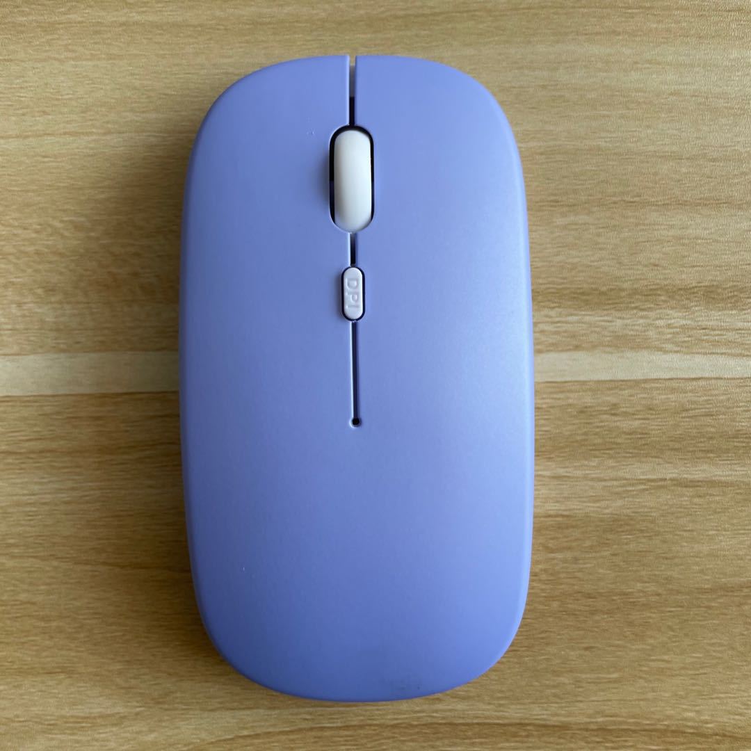Mouse Dual-mode Charging Wireless Mouse in purple color on a wooden surface.
