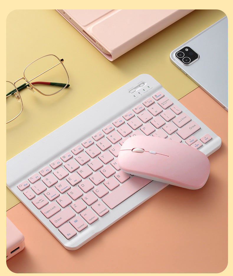 Mouse Dual-mode Charging Wireless Mouse placed beside a pink keyboard on a pastel background.