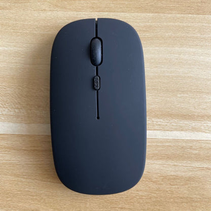 Mouse Dual-mode Charging Wireless Mouse on a wooden surface, showcasing its sleek design and Bluetooth connectivity.
